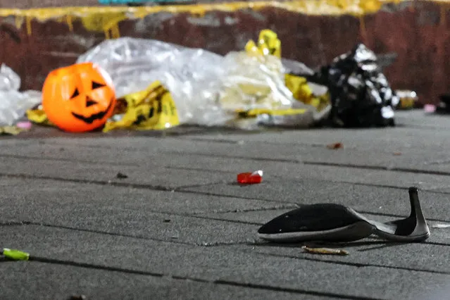 A shoe and a plastic halloween pumpkin are pictured at the scene where a stampede during Halloween festivities killed and injured many people at the popular Itaewon district in Seoul, South Korea on October 30, 2022. (Photo by Yonhap via Reuters)