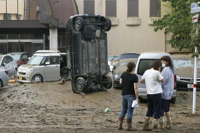 A car stands vertically on a muddy road after being washed away by flood, in Hitoyoshi, Kumamoto prefecture, southwestern Japan, Sunday, July 5, 2020. Heavy rain in the Kumamoto region triggered flooding and mudslides Saturday and left dozens still being stranded at their homes and other facilities. (Photo by Kyodo News via AP Photo)
