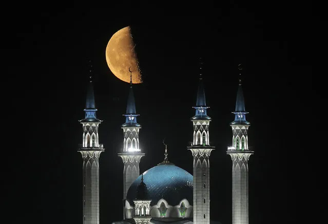 The moon is seen over the Kul-Sharif Mosque lit at night in the Kazan Kremlin, in Kazan, Tatarstan, Russia on July 12, 2020. (Photo by Yegor Aleyev/TASS)