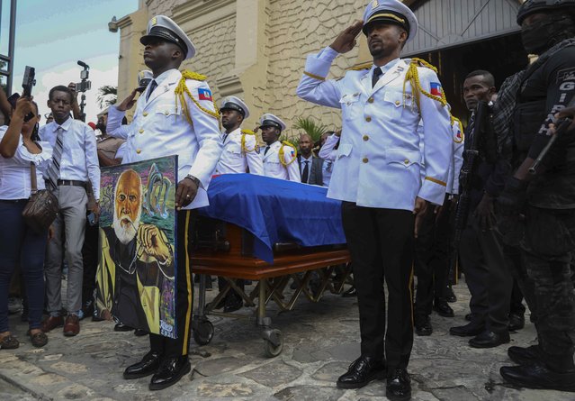 Members of the presidential guard salute next to the coffin of Haitian artist Jean-Pierre Basilic Dantor Franck Étienne, known as Frankétienne, after his funeral ceremony outside a church in the Pétion-ville neighborhood of Port-au-Prince, Haiti, Friday, February 28, 2025. (Photo by Odelyn Joseph/AP Photo)
