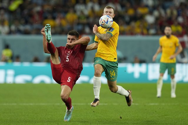 Denmark's Joakim Maehle, left, clears the ball in front Australia's Riley McGree during the World Cup group D soccer match between Australia and Denmark, at the Al Janoub Stadium in Al Wakrah, Qatar, Wednesday, November 30, 2022. (Photo by Francisco Seco/AP Photo)