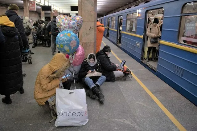 People rest in the subway station being used as a bomb shelter during a rocket attack in Kyiv, Ukraine, Monday, December 5, 2022. Ukraine’s air force said it shot down more than 60 of about 70 missiles that Russia fired on in its latest barrage against Ukraine. It was the latest onslaught as part of Moscow’s new, stepped-up campaign that has largely targeted Ukrainian infrastructure and disrupted supplies of power, water and heat in the country as winter looms. (Photo by Andrew Kravchenko/AP Photo)