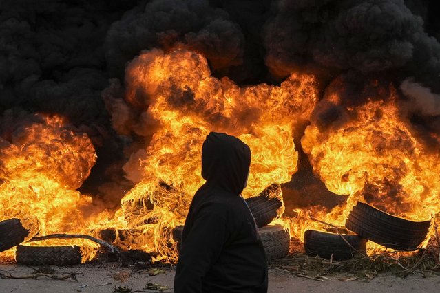 Hezbollah supporters burn tires to block a road link to the international airport during a protest against statements made by U.S. deputy special envoy for Middle East peace Morgan Ortagus after she met with the country's president, in Beirut, Lebanon, Friday, February 7, 2025. (Photo by Bilal Hussein/AP Photo)