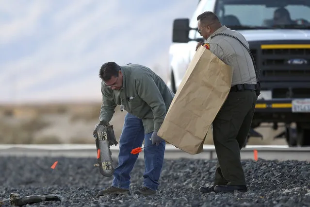 Investigators pick up wreckage of the crash of Virgin Galactic's SpaceShipTwo along a railroad track near Cantil, California, on November 2, 2014. (Photo by David McNew/Reuters)