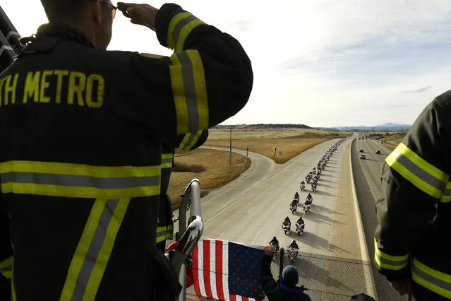 South Metro firefighters Lt. Rob Page, right, and Mark Johnson, left, salute as the funeral procession for Douglas County sheriff's deputy Zackari Parrish passes by on northbound on Highway I-25 on January 5, 2018 in Castle Pines, Colorado. Parrish was shot and killed while responding to a call on December 31, 2017 in Highlands Ranch. (Photo by Helen H. Richardson/The Denver Post)