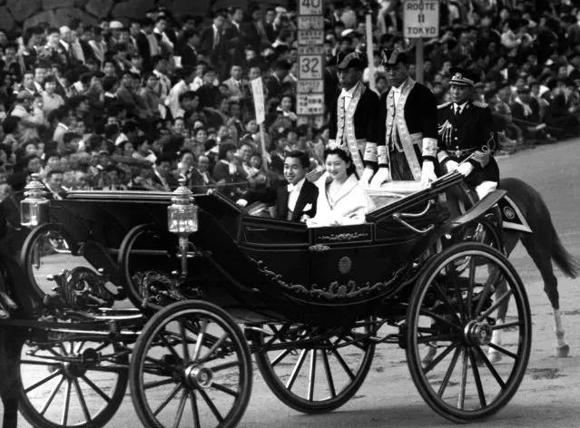 Japan's Crown Prince Akihito (L) and Crown Princess Michiko parade through the streets on their wedding day in Tokyo, Japan, in this photo taken April 10, 1959 and released by Kyodo. (Photo by Reuters/Kyodo News)