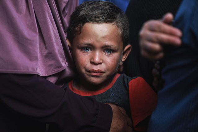A Palestinian child sheds tears while mourning during the funeral ceremony for Palestinians killed as Israeli forces carried out airstrikes on a vehicle in the Al-Atatra area of Beit Lahia, Gaza, on the first day of Eid al-Adha, June 6, 2025. At least four Palestinians were killed in the attack. (Photo by Abdalhkem Abu Riash/Anadolu via Getty Images)