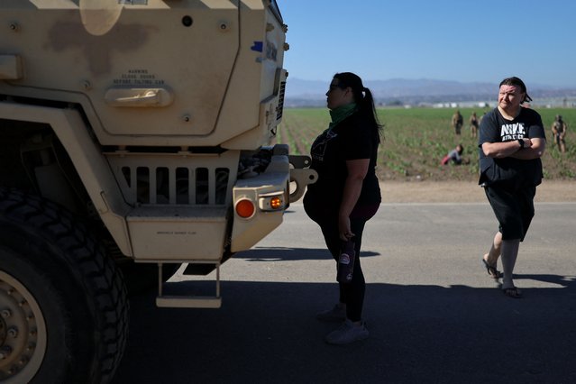 A protester stands in front of a military vehicle approaching an agricultural facility where U.S. federal agents and immigration officers carried out an operation, in Camarillo, California, U.S., July 10, 2025. (Photo by Daniel Cole/Reuters)