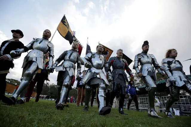 Australian jousting knight Cliff Marisma (C) walks from the arena with jousters from around the world after he won the final of the jousting competition the St Ives Medieval Fair in Sydney, one of the largest of its kind in Australia, September 25, 2016. (Photo by Jason Reed/Reuters)