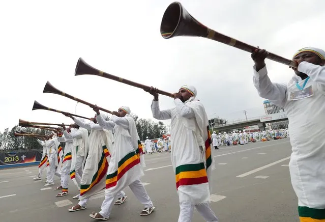 Ethiopian Orthodox deacons blow traditional trumpets during the Meskel Festival to commemorate the discovery of the true cross on which Jesus Christ was crucified on, in Addis Ababa, Ethiopia, September 26, 2020. (Photo by Tiksa Negeri/Reuters)