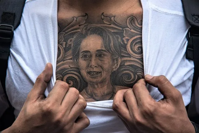 A protester reveals a tattoo of Aung San Suu Kyi on his chest during the demonstration in Bangkok, Thailand on February 1, 2023. Burmese in Thailand gather outside the Myanmar Embassy in Bangkok to mark 2 years since the Myanmar military seized power from a democratically elected civilian government on Febuary 1, 2021. (Photo by Peerapon Boonyakiat/SOPA Images/Rex Features/Shutterstock)