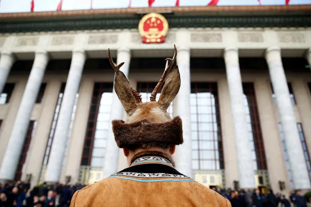 A delegate in traditional costume arrives for the opening session of the National People's Congress (NPC) at the Great Hall of the People in Beijing, China March 5, 2018. (Photo by Thomas Peter/Reuters)