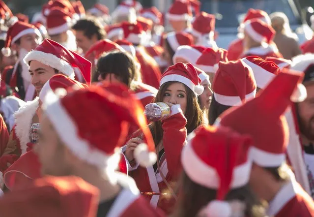 Participants dressed in Santa costumes gather during the annual SantaCon event in London December 6, 2014. (Photo by Neil Hall/Reuters)