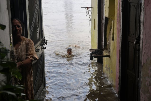 An Indian kid takes a dip in the flooded water of the Yamuna River at Yamuna Bazar in New Delhi, India, 19 August 2025. The Yamuna River in Delhi has crossed the danger mark of 205 meters after a massive water release from upstream barrages, and the Yamuna River is expected to reach 206 meters by 19 August, an advisory issued by the Central Water Commission had said. (Photo by Rajat Gupta/EPA)