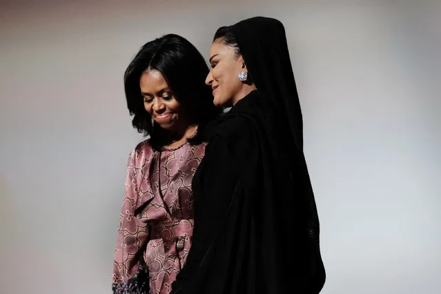 First lady Michelle Obama and Moza bint Nasser, one of the wives of the former emir of Qatar, stand onstage during the World Innovation Summit for Education in Doha on November 4, 2015, where they spoke on the importance of educating girls. (Photo by Bonnie Jo Mount/The Washington Post)