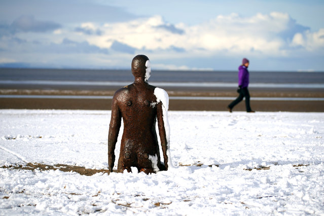 Snow surrounds one of the Anthony Gormley statues called Another Place at Crosby Beach Merseyside, United Kingdom on Friday, March 10, 2023. (Photo by Peter Byrne/PA Images via Getty Images)