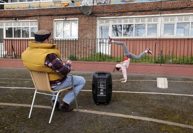 Masie Jane O’Flaherty practices outdoors freestyle dancing, watched by her dad, Jason O’Flaherty, at Bishop Street flats in Dublin on March 5, 2023. (Photo by Alan Betson/The Irish Times)