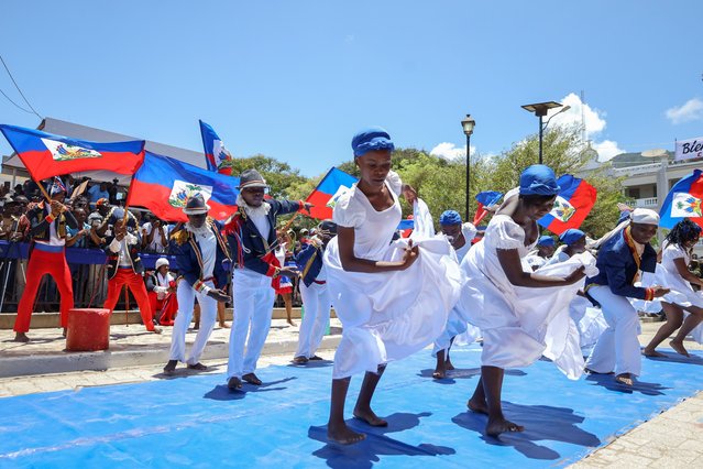 Young people dance during a Flag Day celebration, in Cabo Haitiano, Haiti, 18 May 2025. Prime Minister Alix Didier Fils-Aime called for national unity and collective effort to create the conditions for a constitutional-reform referendum and 'free, inclusive, and credible' elections in a country mired in a deep crisis that has gone a decade without holding a vote. (Photo by Patrice Noel/EPA)