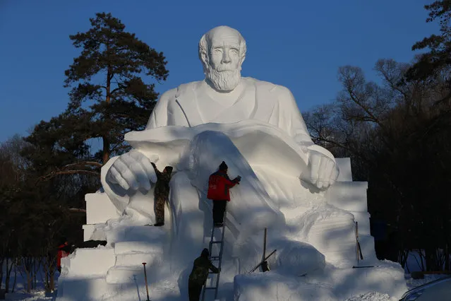Sculptors work on a snow sculpture in the 16th Harbin Ice and Snow World, which will officially open on January 5 on December 22, 2014 in Harbin, China. (Photo by Feature China/Barcroft Media)
