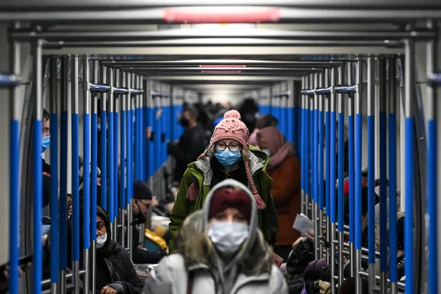 A woman wearing a face mask to protect against the coronavirus disease rides in a metro train in Moscow on December 9, 2020. Russia confirmed 26,190 new Covid-19 cases on December 9. (Photo by Kirill Kudryavtsev/AFP Photo)