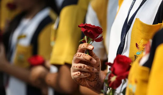 Students of RBK International Academy pay a floral tribute to the victims of Paris Attack infront of the replica of the Eiffel tower in Mumbai, India, 17 November 2015.  More than 130 people have been killed in a series of attacks in Paris on 13 November, according to French officials. Eight assailants were killed, seven when they detonated their explosive belts, and one when he was shot by officers, police said. (Photo by Divyakant Solanki/EPA)