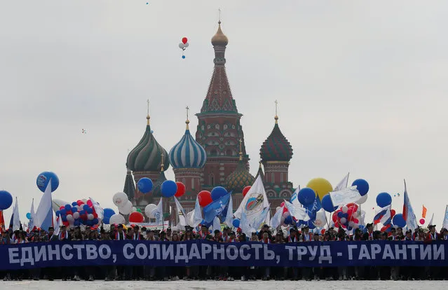 People carry a banner in front of St. Basil's Cathedral during a May Day rally at Red Square in Moscow, Russia on May 1, 2018. (Photo by Maxim Shemetov/Reuters)