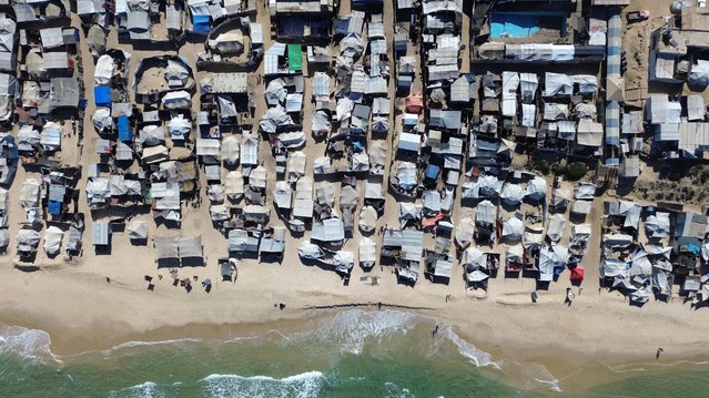 An aerial view of the Al-Mawasi area, where thousands of displaced Palestinians live in makeshift tents by the sea, after the ceasefire agreement between Israel and Hamas in Khan Yunis, Gaza on October 14, 2025. Palestinian families living in makeshift tents in the southern Gaza Strip continue to stay there despite the cold weather conditions. (Photo by Muhammed Eslayeh/Anadolu via Getty Images)