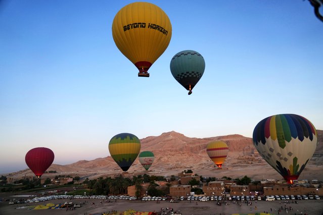Tourists on a hot air balloon ride fly over the Valley of Kings in the southern city of Luxor, Egypt, Saturday, October 4, 2025, where the tomb of Amenhotep III, who ruled ancient Egypt between 1390 B.C. and 1350 B.C., is opened to visitors for the first time in more than two decades. (Photo by Amr Nabil/AP Photo)