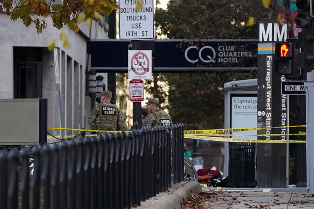 National Guard members stand in a cordoned-off area with evidence markers placed on the ground, after two National Guard members were shot near the White House in Washington, D.C., on November 26, 2025. (Photo by Nathan Howard/Reuters)