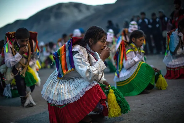 Costumed dancers parade at a chapel on the first day of the annual Qoyllur Rit'i festival on May 27, 2018 in Ocongate, Peru. (Photo by Dan Kitwood/Getty Images)