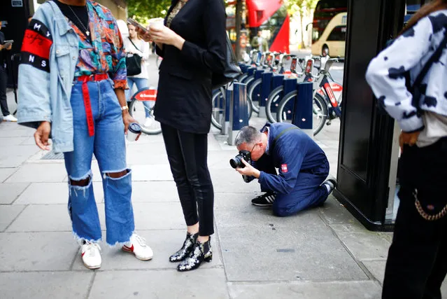 A man photographs shoes outside the BFC Showspace at London Fashion Week Men's, in London, Britain June 10, 2018. (Photo by Henry Nicholls/Reuters)
