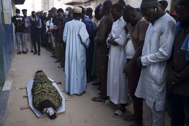 Friends and relatives of Elhaji Cisse attend his funeral ceremony in front a local mosque in Dakar, Senegal, Monday, June 5, 2023. According to the family, the 26-year-old student was shot after leaving a mosque at a moment where security forces and demonstrators clashed nearby, last June 2. (Photo by Leo Correa/AP Photo)