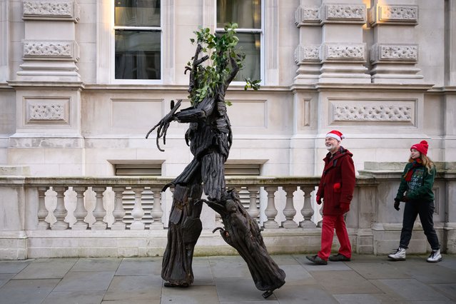 A stilt-walker dressed as a tree-spirit “Ent” moves into position as environmental campaign groups demonstrate outside the Department of Energy Security and Net Zero, as they call for the closure of the Drax power station, on December 02, 2024 in London, England. Climate demonstrators are calling for an end to government subsidies for the Drax Power Plant in North Yorkshire, which generates electricity by burning wood pellets sourced from trees in North America. (Photo by Leon Neal/Getty Images)