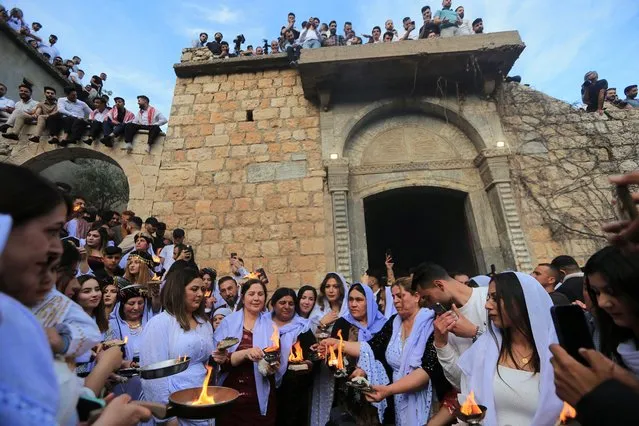 Iraqi Yazidis visit the Lalish Temple, on the day of a ceremony for the occasion of Red Wednesday, the celebration of the Yazidi New Year, in Shekhan district, in Duhok province, Iraq on April 18, 2023. (Photo by Ari Jalal/Reuters)