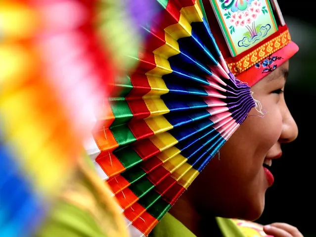 Exiled Tibetan folk artist wearing Tibetan traditional costumes wait for the arrival of unseen The 14th Dalai Lama, the spiritual leader of Tibet during “Thank you Karnataka” in Bangalore, India 10 August 2018. Over Hundreds of exiled Tibetan people gathered to express their gratitude to India via “Thank you Karnataka” event aimed to recognize and honor the people and Karnataka state government for their steadfast support and commitment to the Tibetan community. The exiled Tibetan have five settlements in Karnataka, as they arrived 60 years ago to India as refugees. Byalukuppe situated about 220 km west of Bangalore is the largest Tibetan settlement outside Tibet. (Photo by Jagadeesh N.V./EPA/EFE)