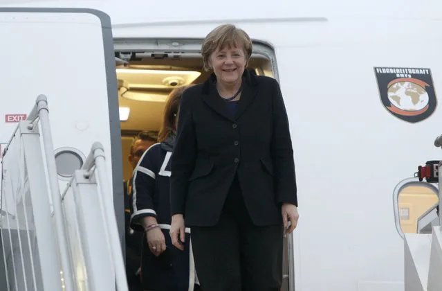 Germany's Chancellor Angela Merkel walks down the stairs upon her arrival at an airport near Minsk, February 11, 2015. (Photo by Valentyn Ogirenko/Reuters)