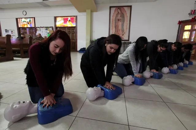 Residents who are volunteering to take part in forming a human chain for crowd control during Pope Francis' visit to Mexico take part in a CPR and first aid training at a church in Ciudad Juarez, January 5, 2016. (Photo by Jose Luis Gonzalez/Reuters)