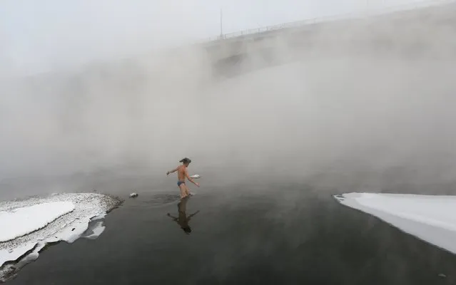 Mikhail Shakov, 23, who recently left the army and is a member of the Cryophile winter swimmers club, enters the icy water of the Yenisei River on the first day after returning from military service in the Siberian city of Krasnoyarsk, Russia, November 21, 2015. The air temperature was some minus 27 degrees Celsius. For Shakov, swimming is a way of disconnecting from daily life and setting his troubles to one side. "All problems leave me," he says. "The world around me seems beautiful". (Photo by Ilya Naymushin/Reuters)