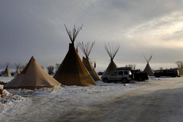 The rising sun illuminates tipis inside the Oceti Sakowin camp as “water protectors” continue to demonstrate against plans to pass the Dakota Access pipeline near the Standing Rock Indian Reservation, near Cannon Ball, North Dakota, U.S., December 3, 2016. (Photo by Lucas Jackson/Reuters)