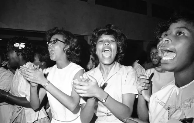 Young girls yell cheers as athletes Jackie Robinson and Floyd Patterson addressed a rally in Birmingham, Ala., May 14, 1963. They talked to black youths who have been demonstrating for the past weeks. Earlier Monday the two athletes joined integration leaders speaking to an adult black audience. (Photo by AP Photo)