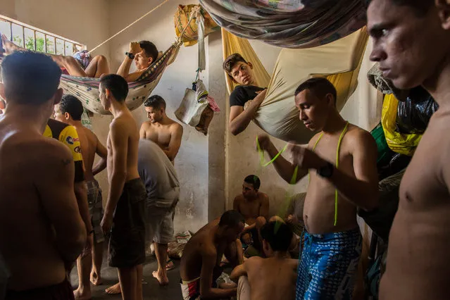 In this November 7, 2016 photo, suspects of violent crime crowd a holding cell at the municipal police station in Cumana, Sucre state, Venezuela. Police are reluctant to make mass arrests of pirates robbing and killing fishermen at sea because the jails are already packed full, with prisoners sleeping in shifts at night. (Photo by Rodrigo Abd/AP Photo)
