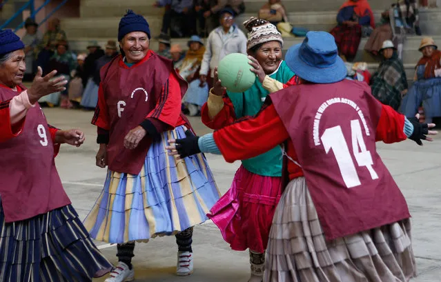 In this February 11, 2105 photo, 72-year-old Aurea Murillo prepares to make a pass during a handball match among elderly Aymara indigenous women in El Alto, Bolivia. Dozens of traditional Aymara grandmothers ease many of the aches and pains of aging by practicing a sport that is decidedly untraditional in Bolivia: team handball. (Photo by Juan Karita/AP Photo)