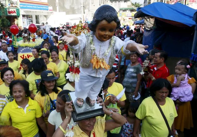 A devotee carries a Sto. Nino (infant Jesus) replica during a procession in Manila January 16, 2016, a day before the annual of the feast day of Sto. Nino on Sunday. (Photo by Romeo Ranoco/Reuters)