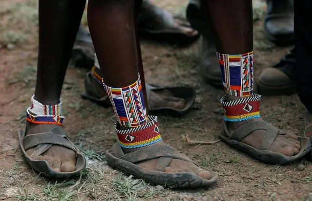 Maasai moran athletes wearing recycled tire shoes prepare to throw a traditional club, known as rungu, during the 2016 Maasai Olympics at the Sidai Oleng Wildlife Sanctuary, at the base of Mt. Kilimanjaro, near the Kenya-Tanzania border in Kimana, Kajiado, Kenya December 10, 2016. (Photo by Thomas Mukoya/Reuters)