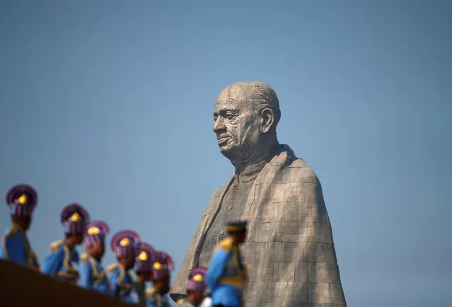 Police officers stand near the “Statue of Unity” portraying Sardar Vallabhbhai Patel, one of the founding fathers of India, during its inauguration in Kevadia, in the western state of Gujarat, India, October 31, 2018. (Photo by Amit Dave/Reuters)