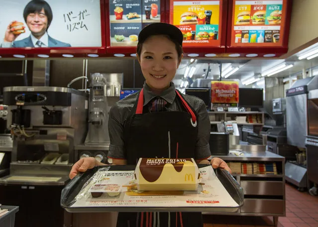 McDonald's Japan Swing Manager Miwa Suzuki presents a box of McChoco Potato on January 25, 2016 in Tokyo, Japan. The McChoco Potato, McDonald's Japan's special winter menu, french fries covered in chocolate and white chocolate sauces will be available in McDonald's restaurants on January 26, 2016 until around mid February. (Photo by Christopher Jue/Getty Images)