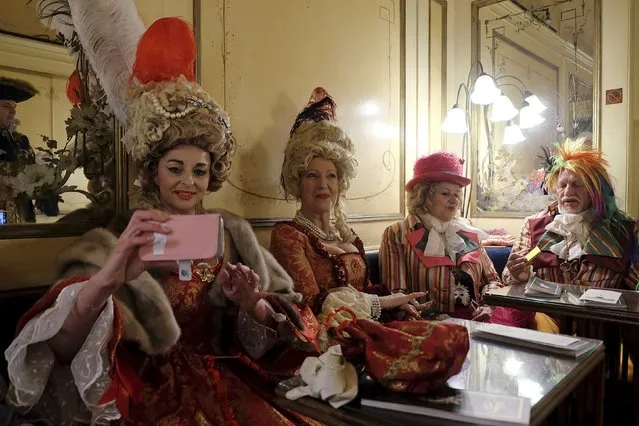 Revellers are seen in the Caffe Florian coffee shop in Saint Mark's Square during the Venice Carnival, Italy January 31, 2016. (Photo by Manuel Silvestri/Reuters)