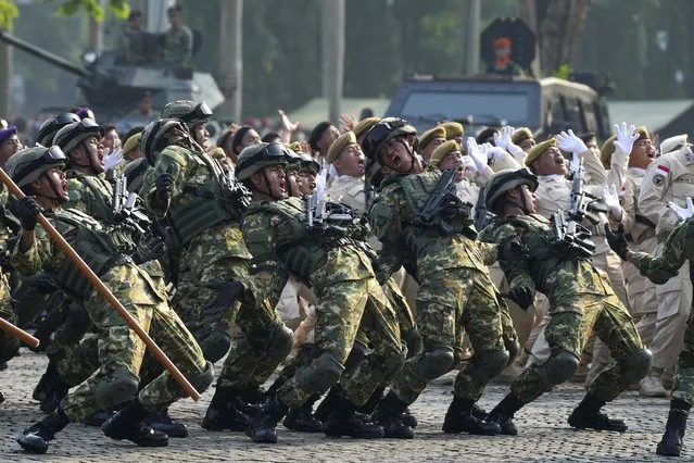Soldiers perform during a parade marking the 78th anniversary of the Indonesian Armed Forces in Jakarta, Indonesia, Thursday, October 5, 2023. (Photo by Tatan Syuflana/AP Photo)