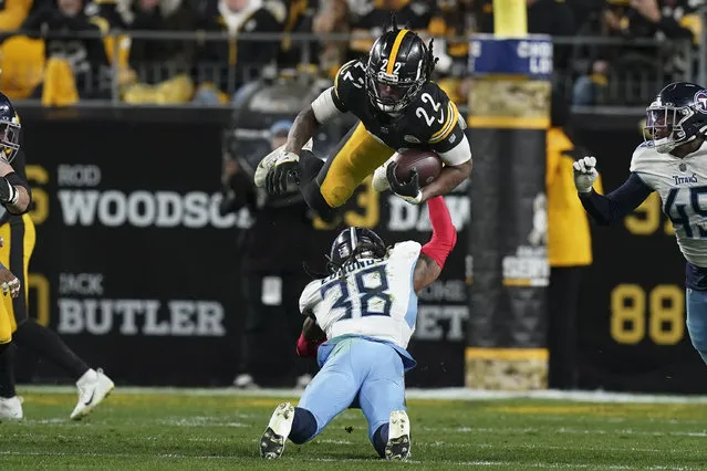 Pittsburgh Steelers running back Najee Harris (22) leaps over Tennessee Titans safety Terrell Edmunds (38) during the second half of an NFL football game Thursday, November 2, 2023, in Pittsburgh. (Photo by Matt Freed/AP Photo)