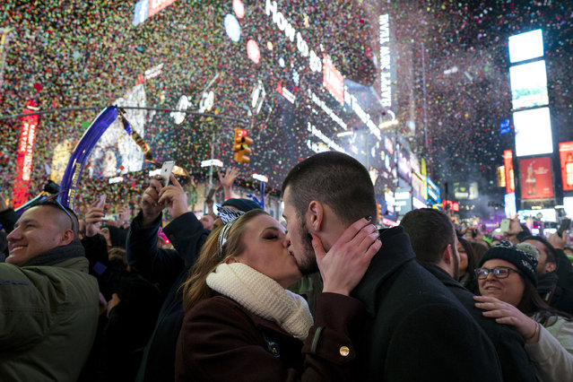 Kaitlin Olivi of Yonkers, N.Y., and Lucas Pereira, of Sayreville, N.J., kiss as confetti falls during a celebration of the new year in New York's Times Square, Sunday, January 1, 2017. (Photo by Craig Ruttle/AP Photo)